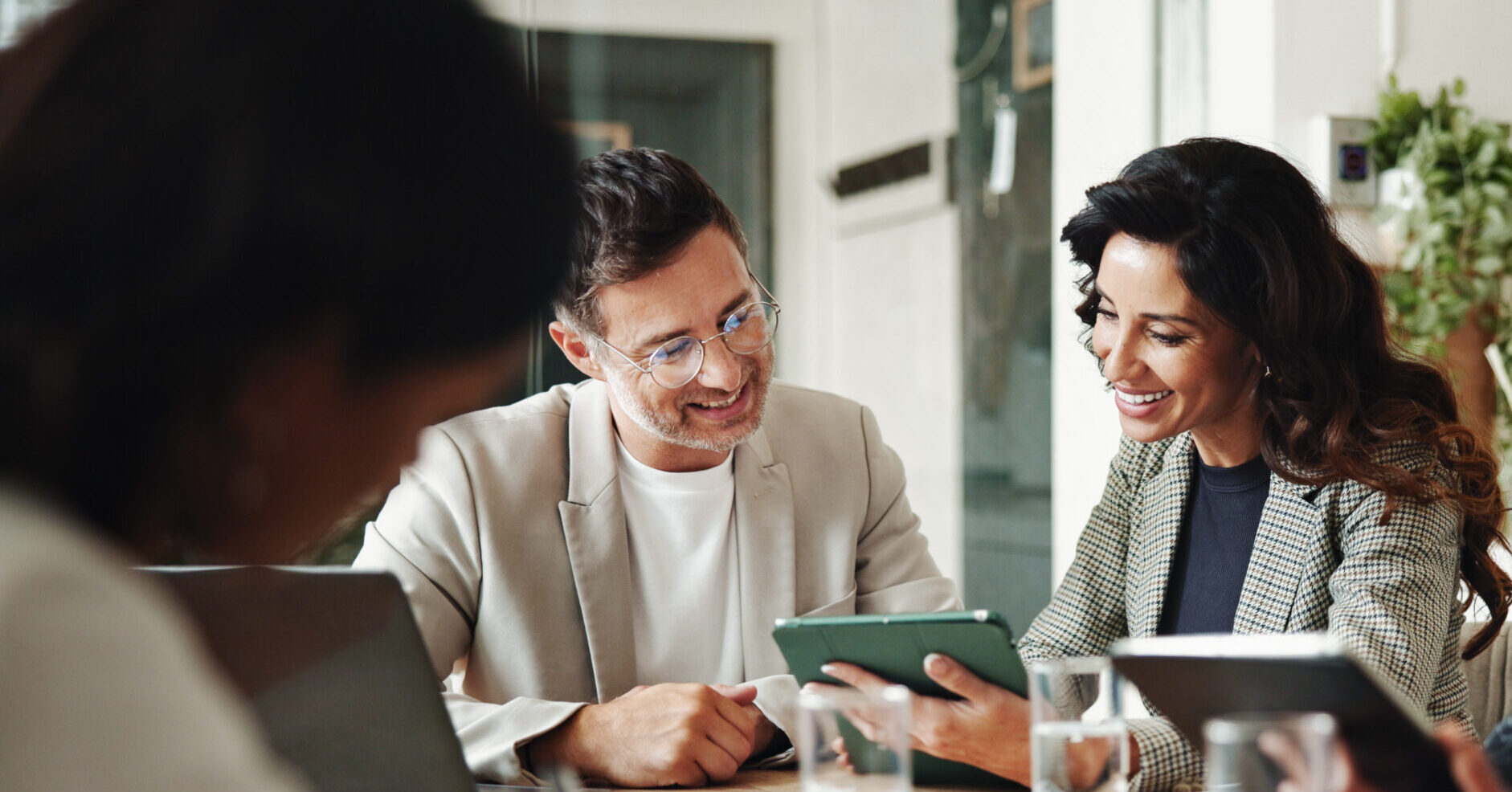 Meeting, technology and business people in office for finance investment with company with online. Collaboration, discussion and financial management team with profit or revenue margin report